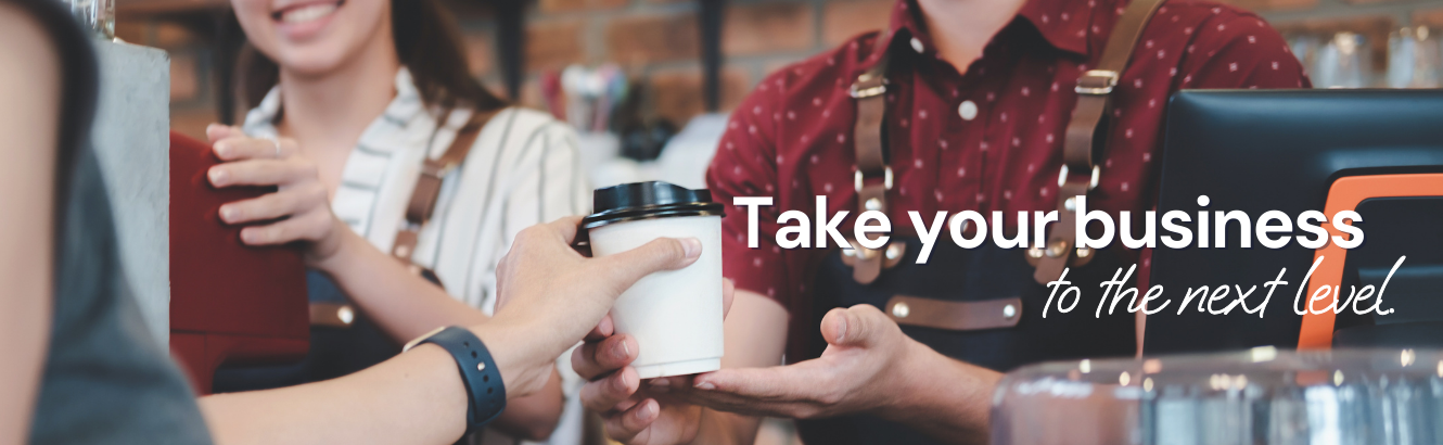 A customer receiving a cup of coffee from a barista.