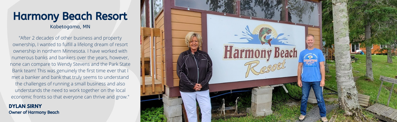 two people standing in front of sign that says Harmony Beach Resort