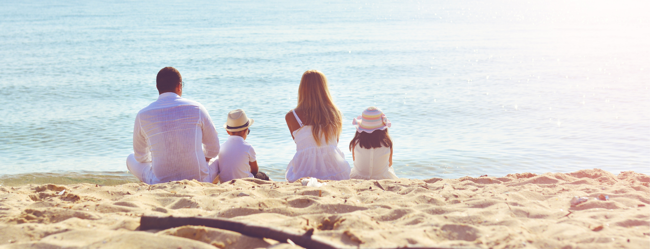 A family sitting on the beach