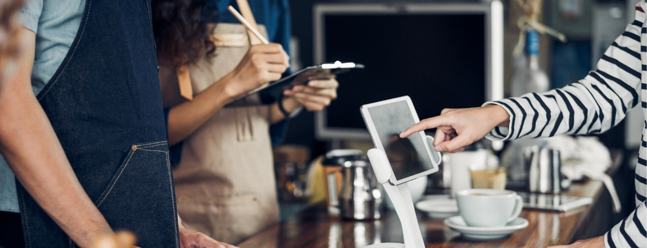 Coffee shop employees using touch screen