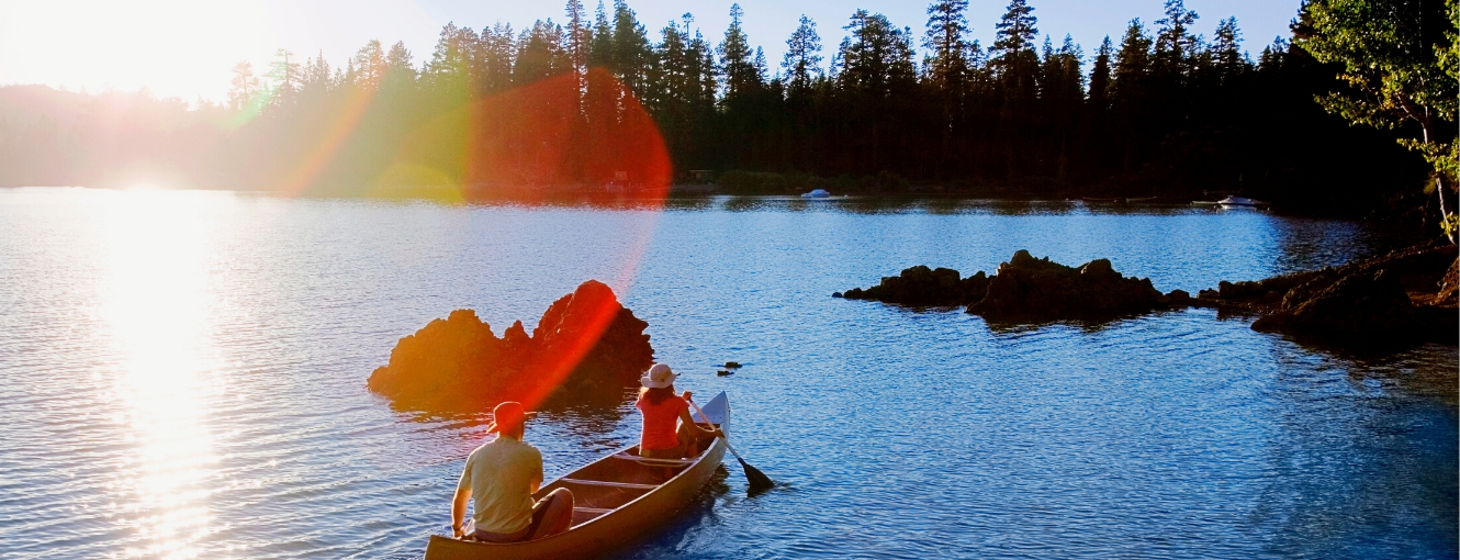 Two people canoeing on a lake