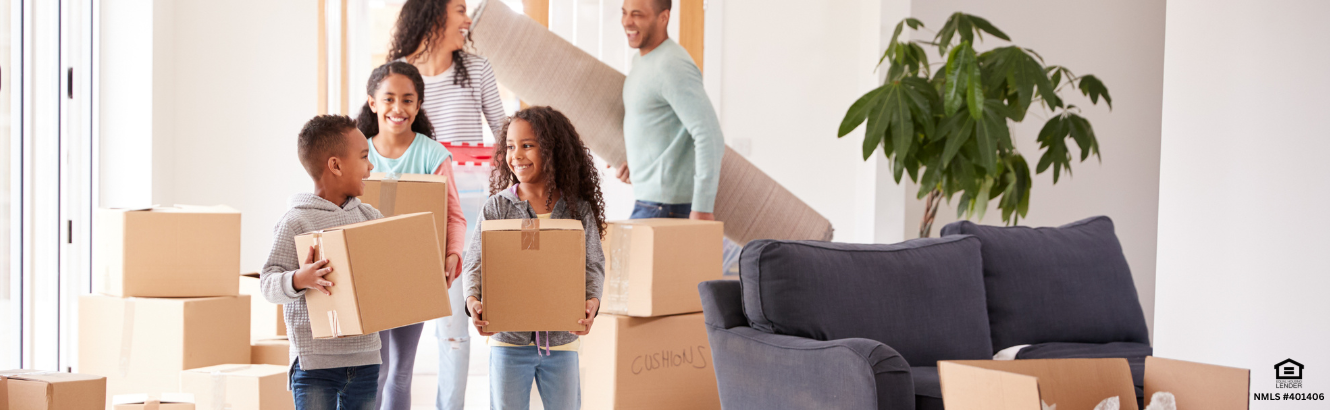 family holding moving boxes as they move in to new home